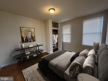 a bedroom with a bed window and furniture