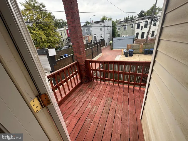 a balcony with wooden floor in front of it