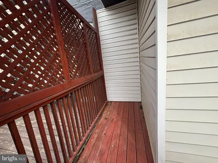 a view of a balcony with wooden floor