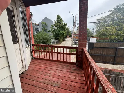 a balcony with wooden floor in front of it