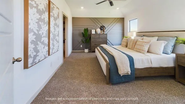 a bedroom with a bed and painting on the wall
