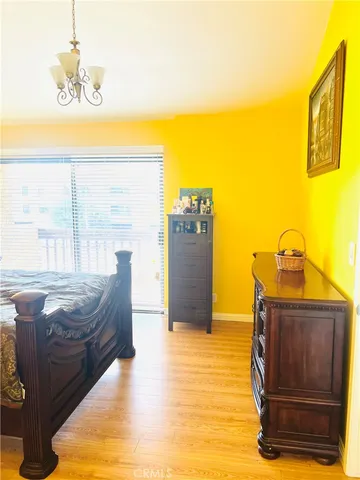 a spacious bedroom with a bed and cabinets