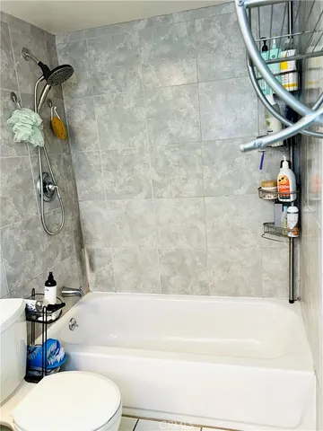 a bathroom with a toilet and a bathtub