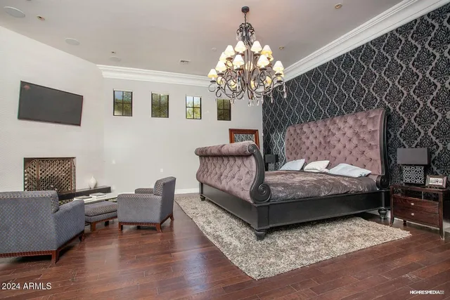 a front view of a house with garden and a tree