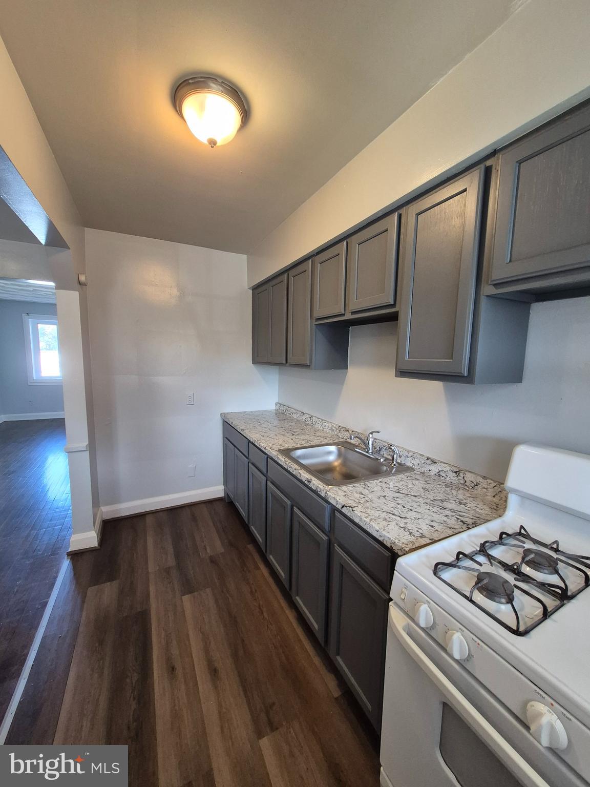 2863 Edgecombe Circle South Baltimore, MD 21215 - Photo 11 of 31 a kitchen that has a sink and a stove