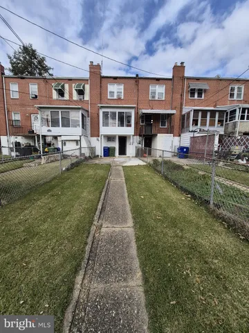 a front view of a residential apartment building with a yard