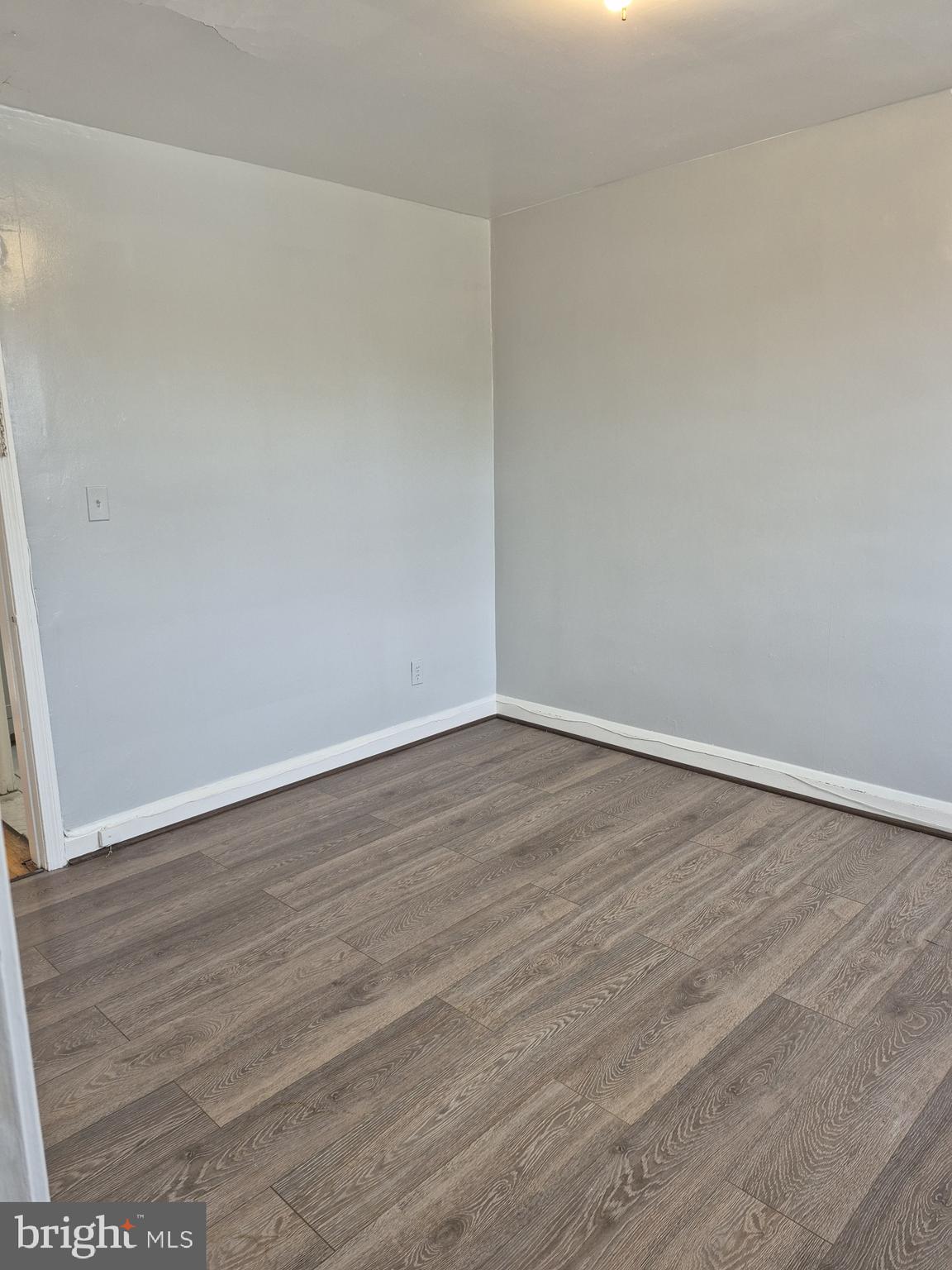 2863 Edgecombe Circle South Baltimore, MD 21215 - Photo 19 of 31 a view of an empty room with wooden floor