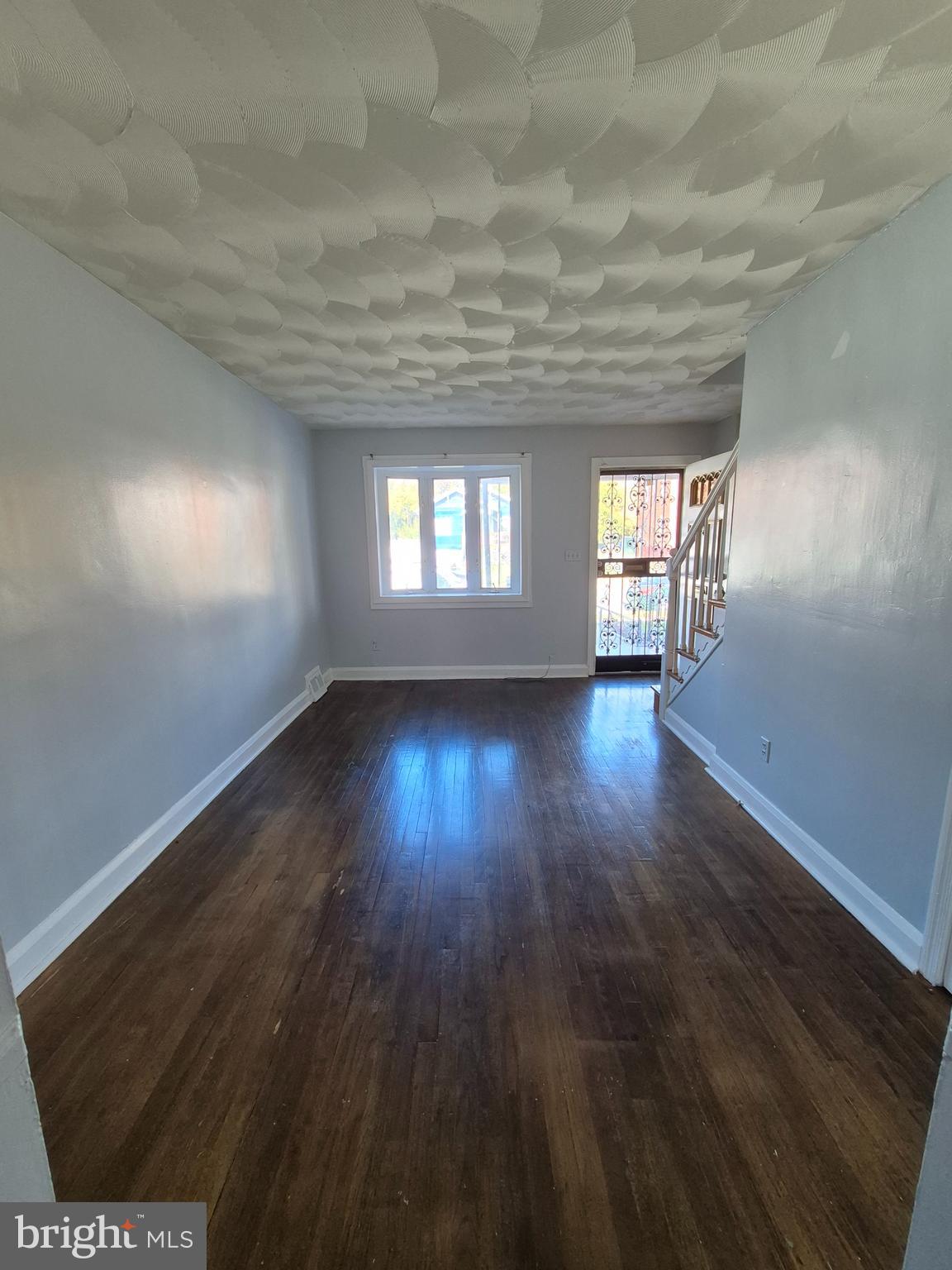 2863 Edgecombe Circle South Baltimore, MD 21215 - Photo 4 of 31 an empty room with wooden floor and windows