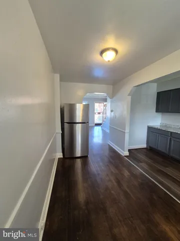 a kitchen with a refrigerator and a stove