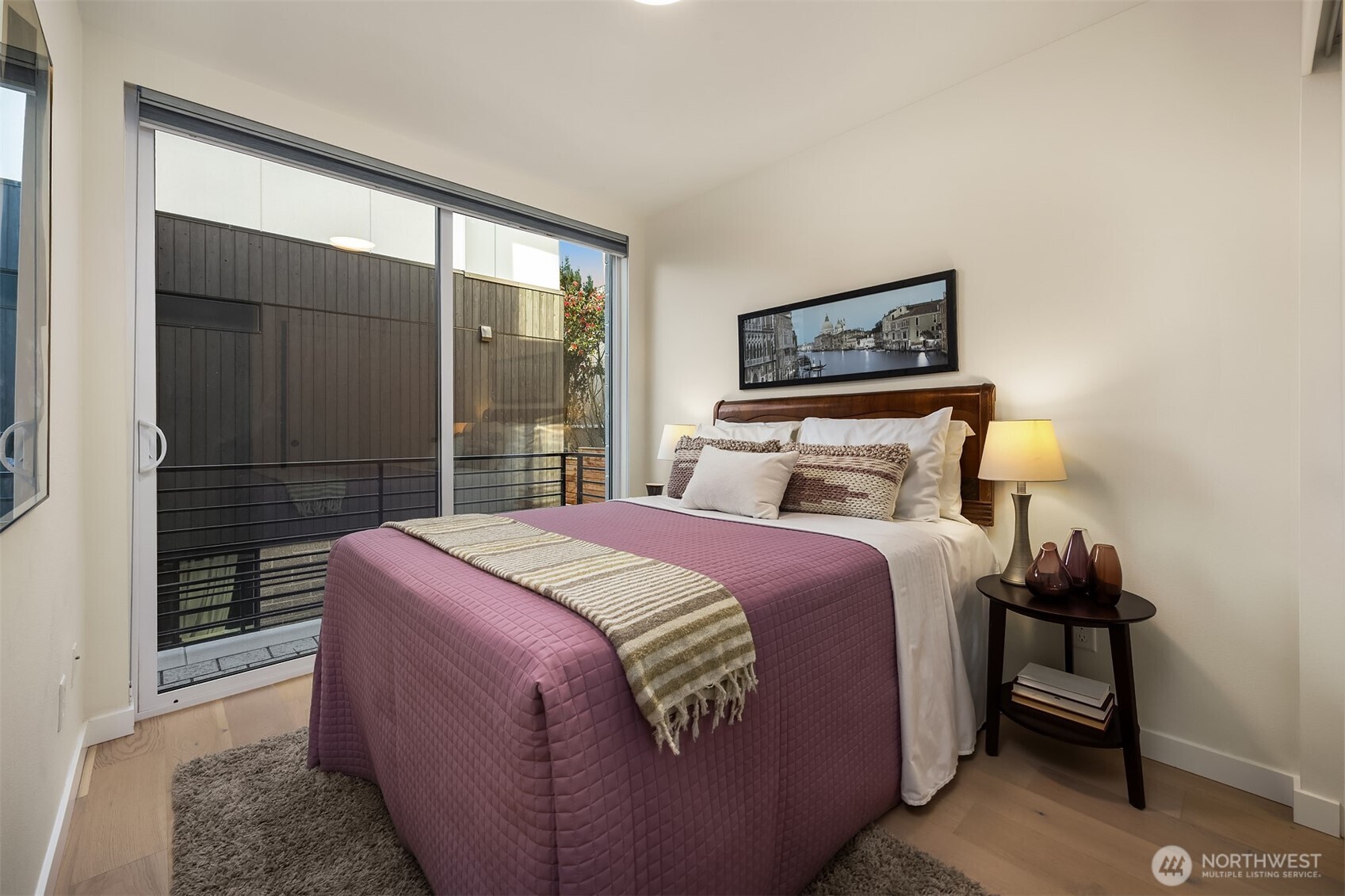 2314 B Fairview Avenue East Seattle, WA 98102 - Photo 14 of 32 a bedroom with a bed and wooden floor
