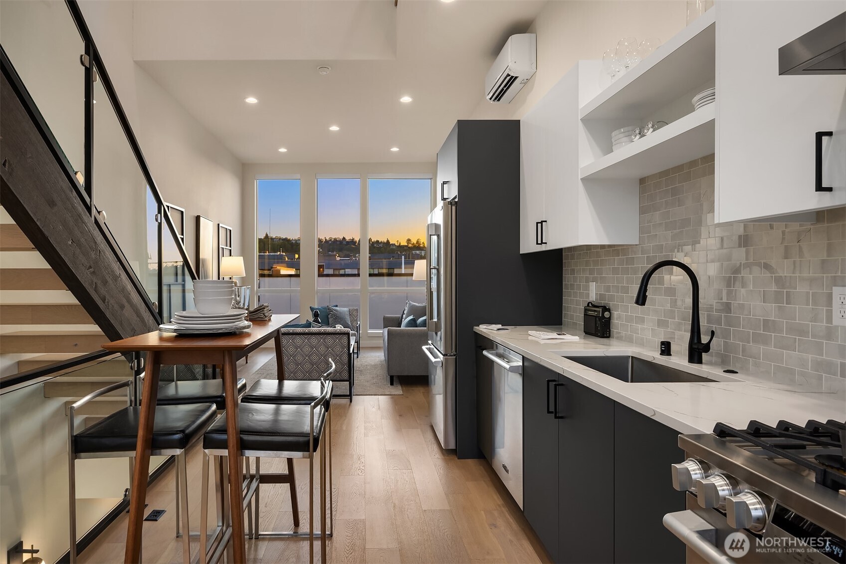 2314 B Fairview Avenue East Seattle, WA 98102 - Photo 3 of 32 a kitchen with sink a stove and chairs with wooden floor