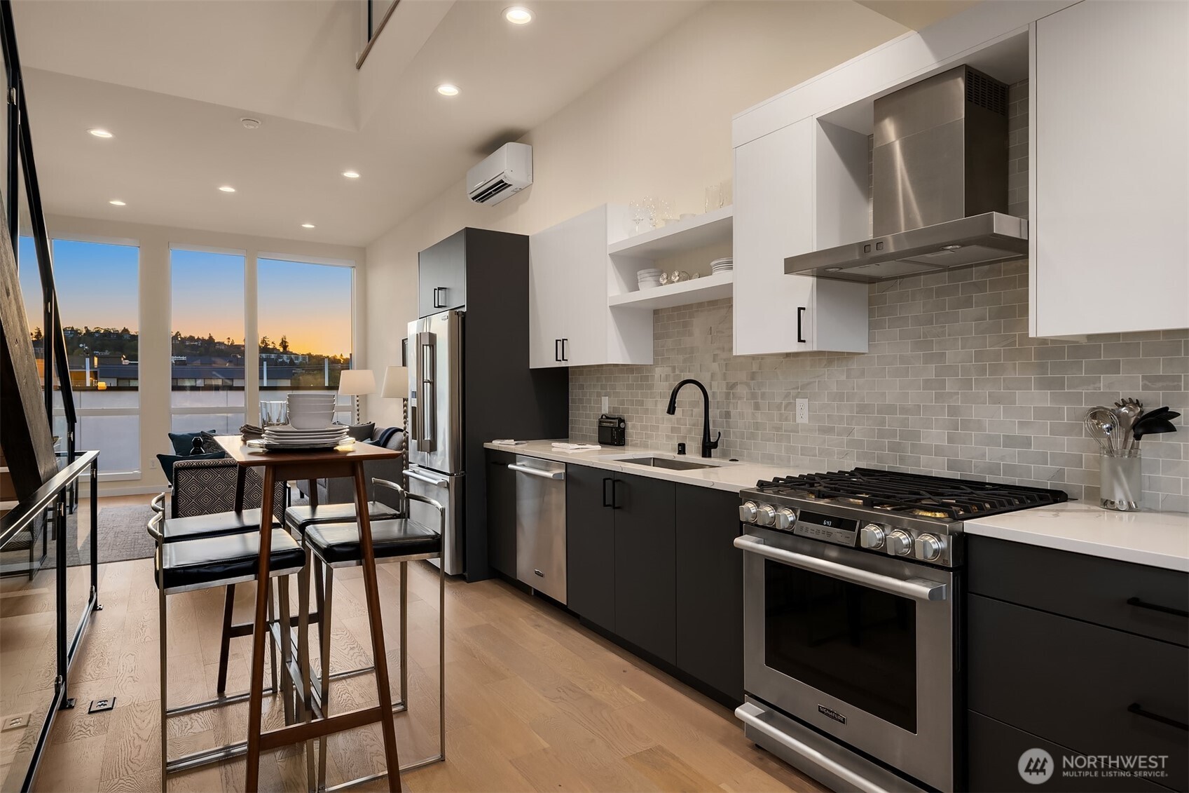 2314 B Fairview Avenue East Seattle, WA 98102 - Photo 4 of 32 a kitchen with stainless steel appliances a stove a sink a stove a refrigerator cabinets and a dining table