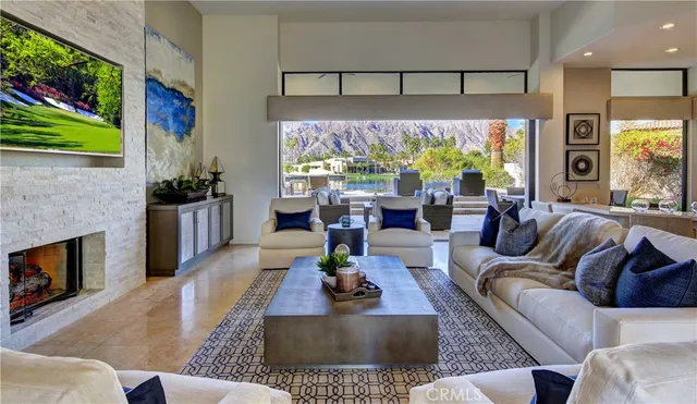 a living room with furniture large window and a fireplace