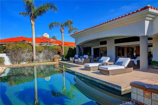 a view of a patio with swimming pool table and chairs