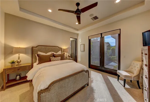 a bedroom with a bed couch and a window
