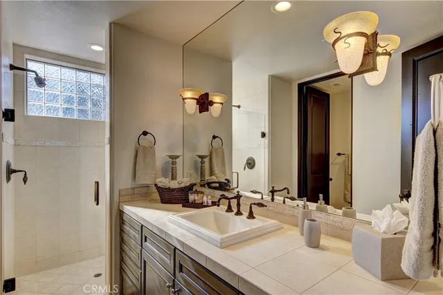 a bathroom with a sink a mirror and a shower