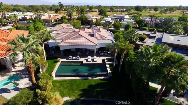 an aerial view of a house with yard and parking