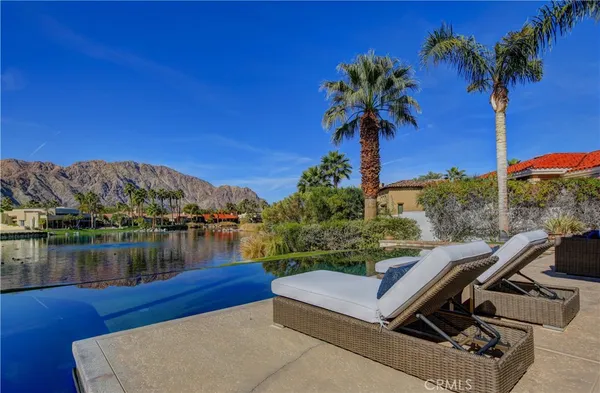 a view of a terrace with couches and wooden fence