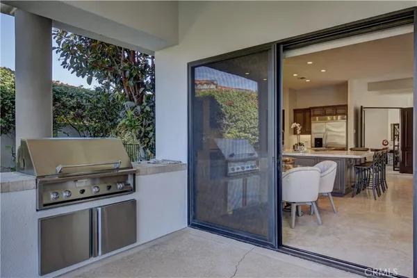 a kitchen with a stove a refrigerator and a dining table