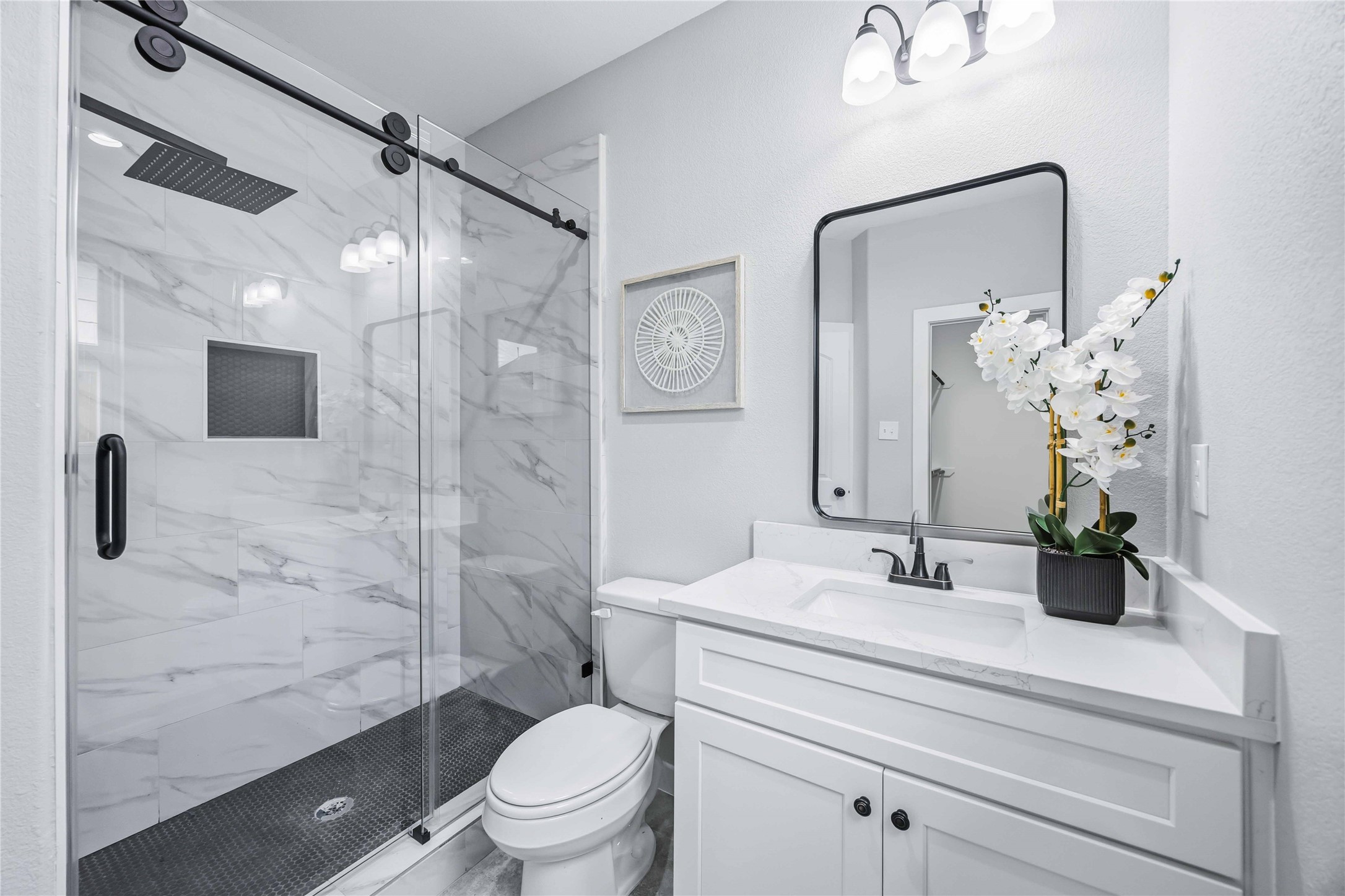 7316 Victoria Street Houston, TX 77020 - Photo 11 of 21 The primary bathroom features stand up shower design with a sleek glass enclosure, elegant marble style tile.