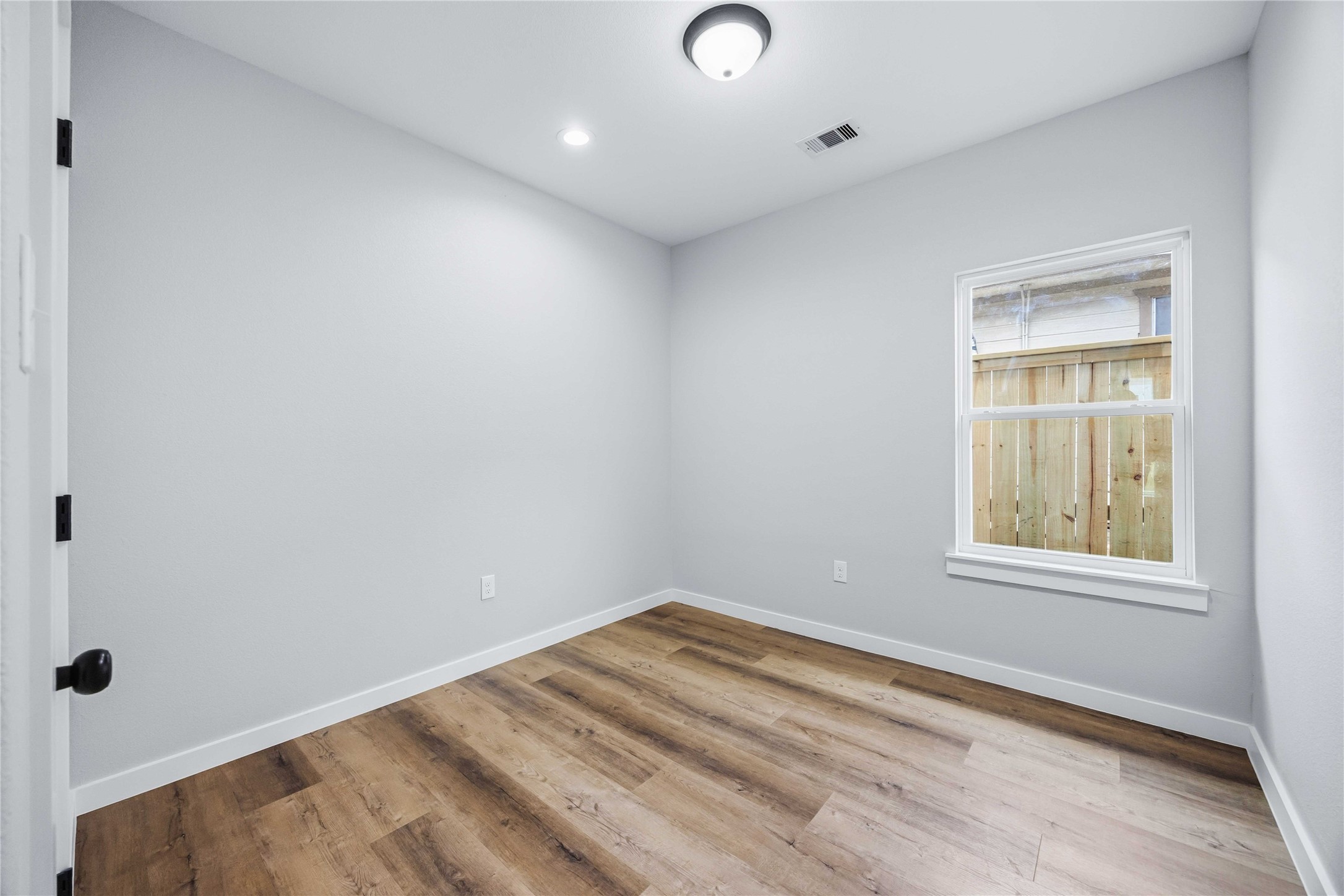 7316 Victoria Street Houston, TX 77020 - Photo 13 of 21 Bedroom 2 features neutral walls, wood flooring plenty of light.