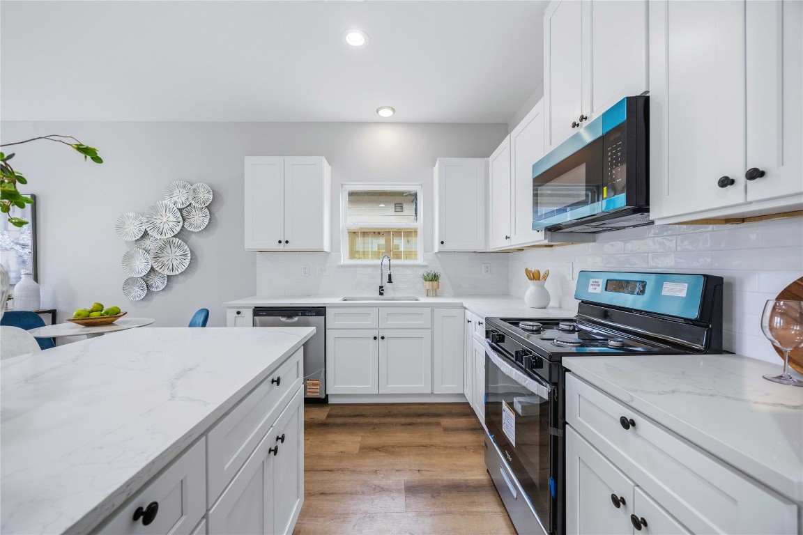 7316 Victoria Street Houston, TX 77020 - Photo 6 of 21 a kitchen with stainless steel appliances a stove a sink and a microwave