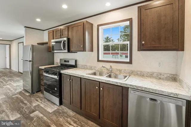 a kitchen with a sink stove and refrigerator