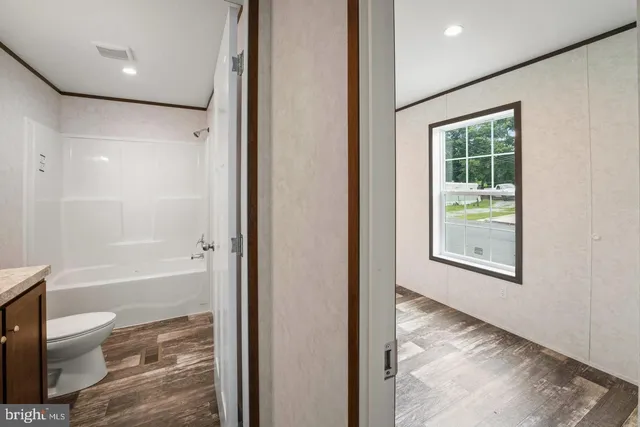 a bathroom with a granite countertop toilet a sink and a bathtub