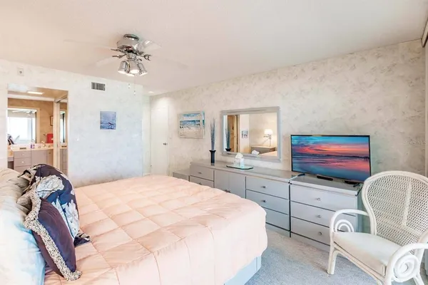 a bedroom with a bed and chandelier