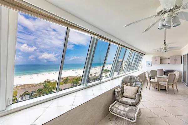 a very nice looking room with a large window and furniture