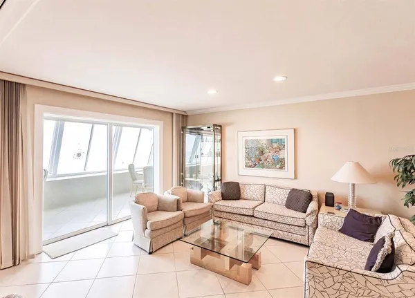 a living room with furniture and a floor to ceiling window
