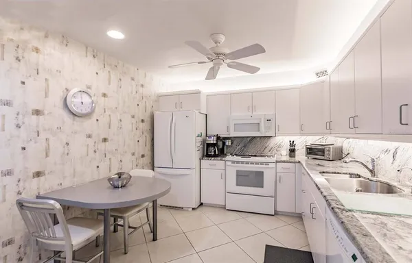 a kitchen with a stove a sink and a refrigerator