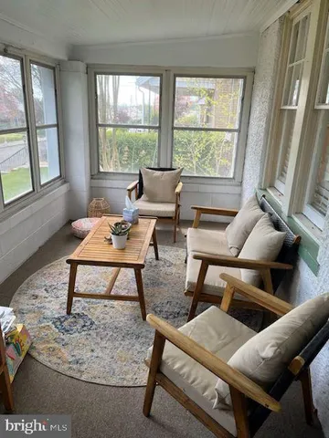 a living room with furniture a rug and a large window
