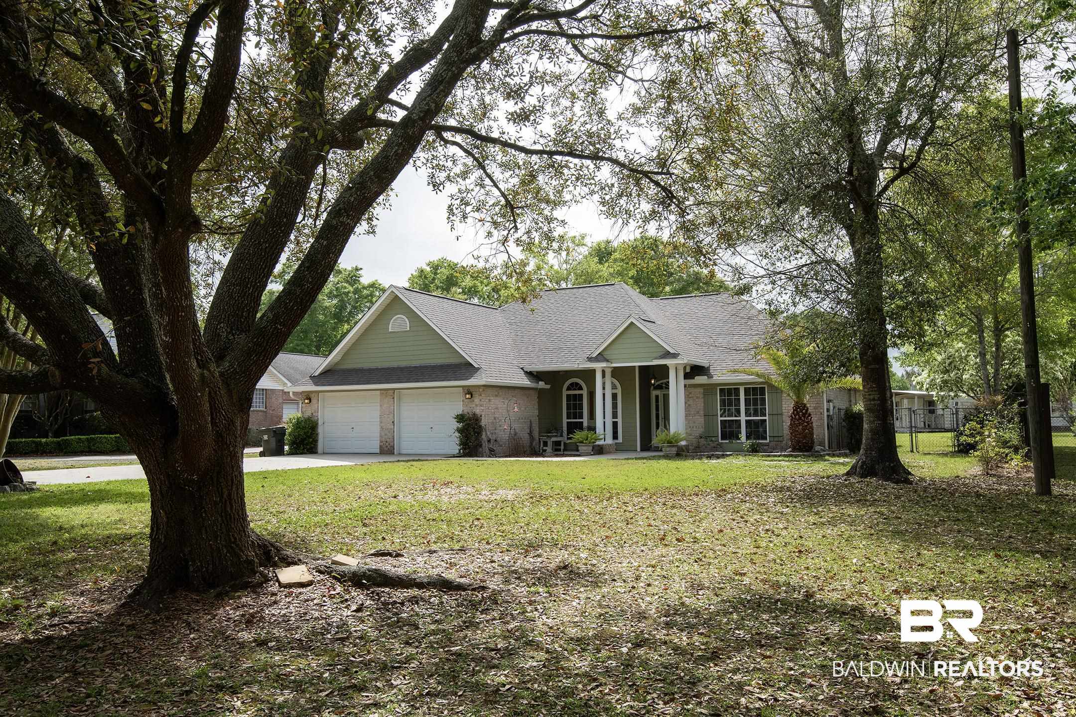 10093 Willis Road Foley, AL 36535 - Photo 33 of 33 View of front of property with a front lawn, a garage, concrete driveway, a porch, and a shingled roof