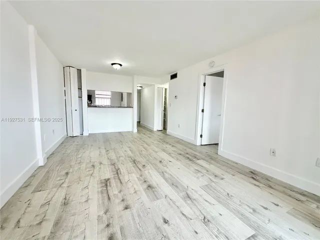 a view of a kitchen with wooden floor and a sink