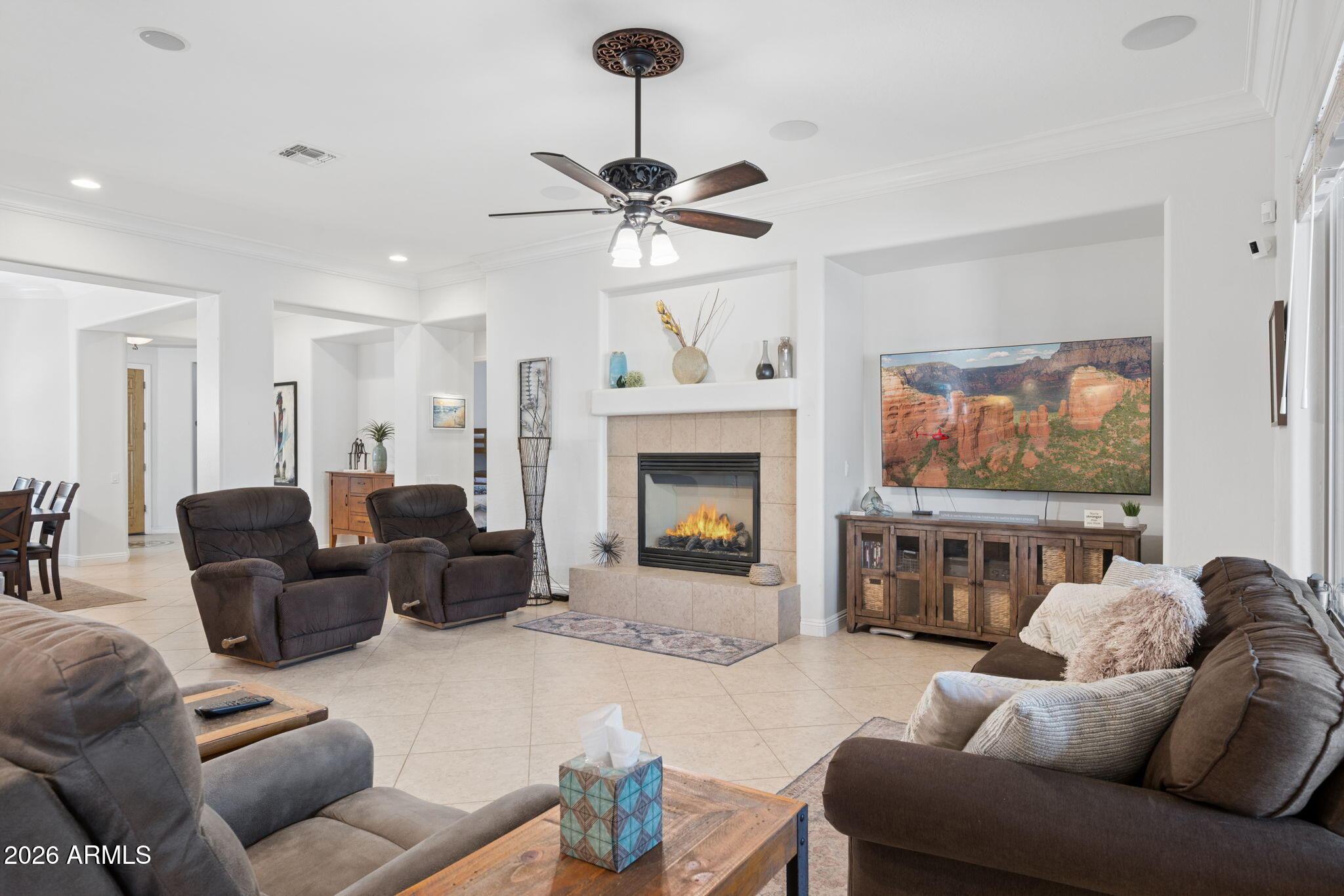 5508 West Parsons Road Phoenix, AZ 85083 - Photo 13 of 48 a living room with furniture a fireplace and a flat screen tv