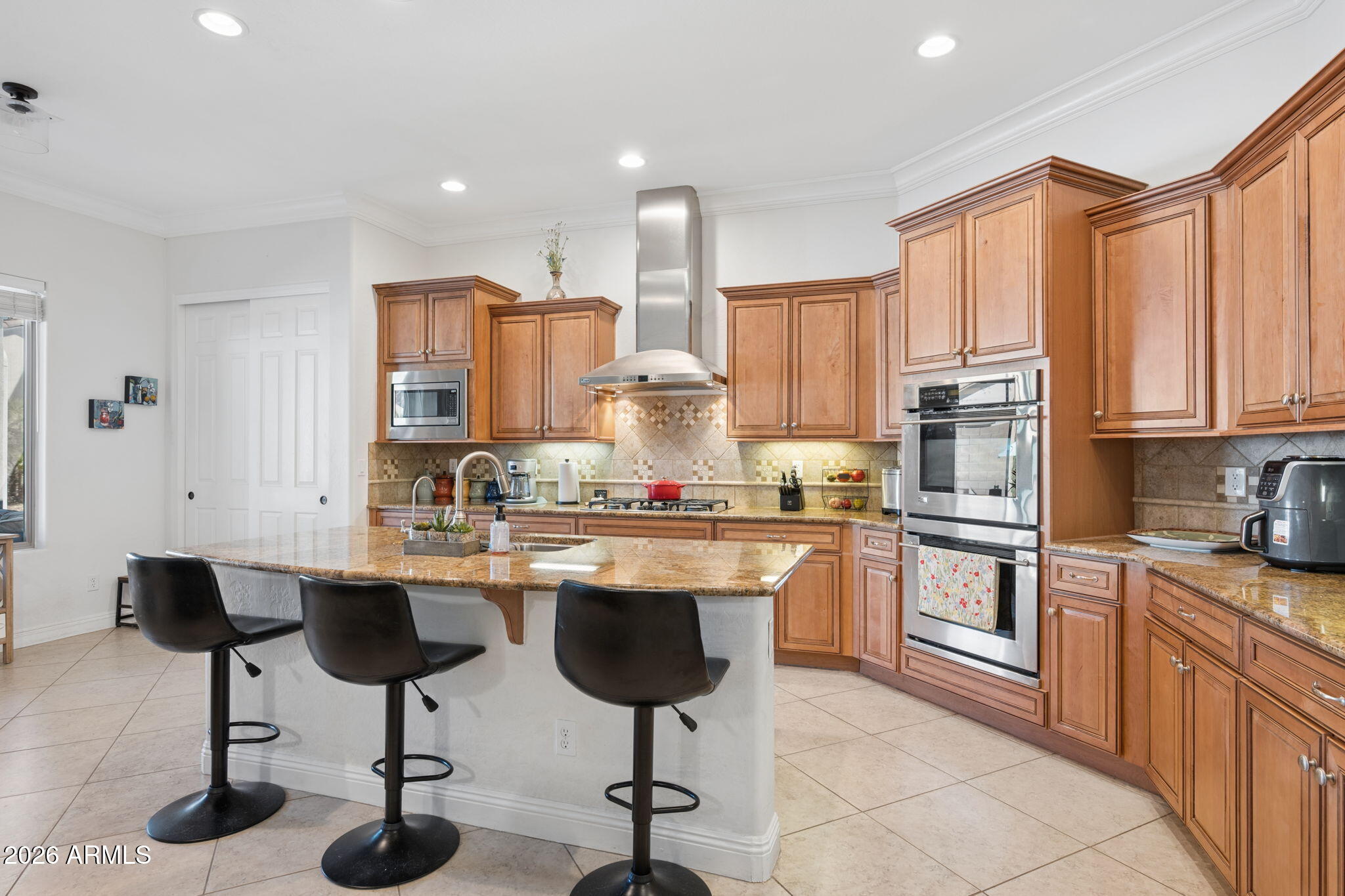 5508 West Parsons Road Phoenix, AZ 85083 - Photo 16 of 48 a kitchen with stainless steel appliances granite countertop a stove a sink refrigerator and cabinets