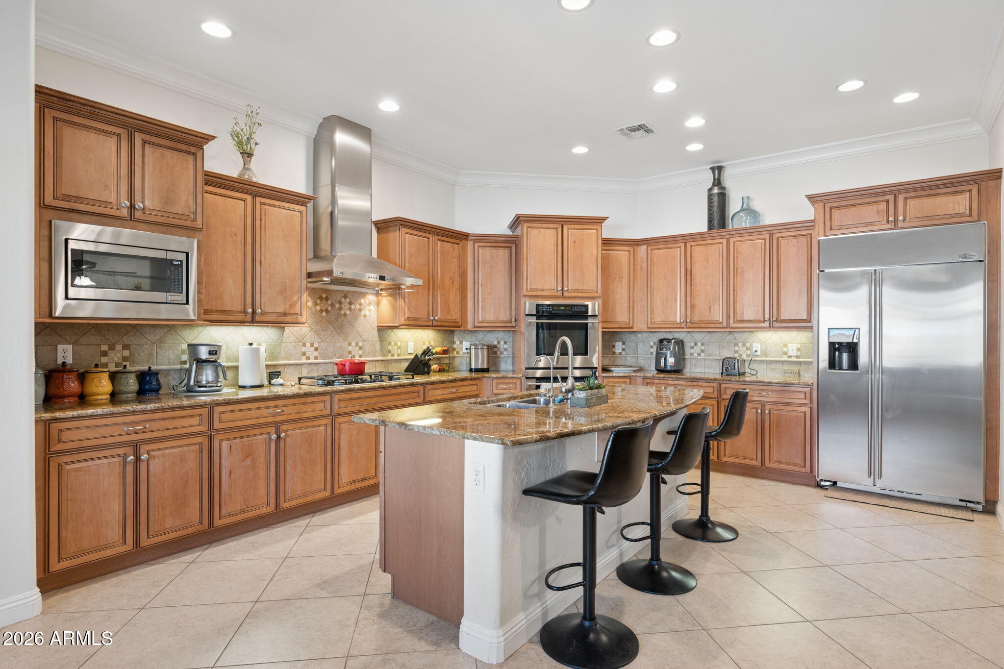5508 West Parsons Road Phoenix, AZ 85083 - Photo 17 of 48 a kitchen with stainless steel appliances granite countertop a table chairs sink refrigerator and cabinets