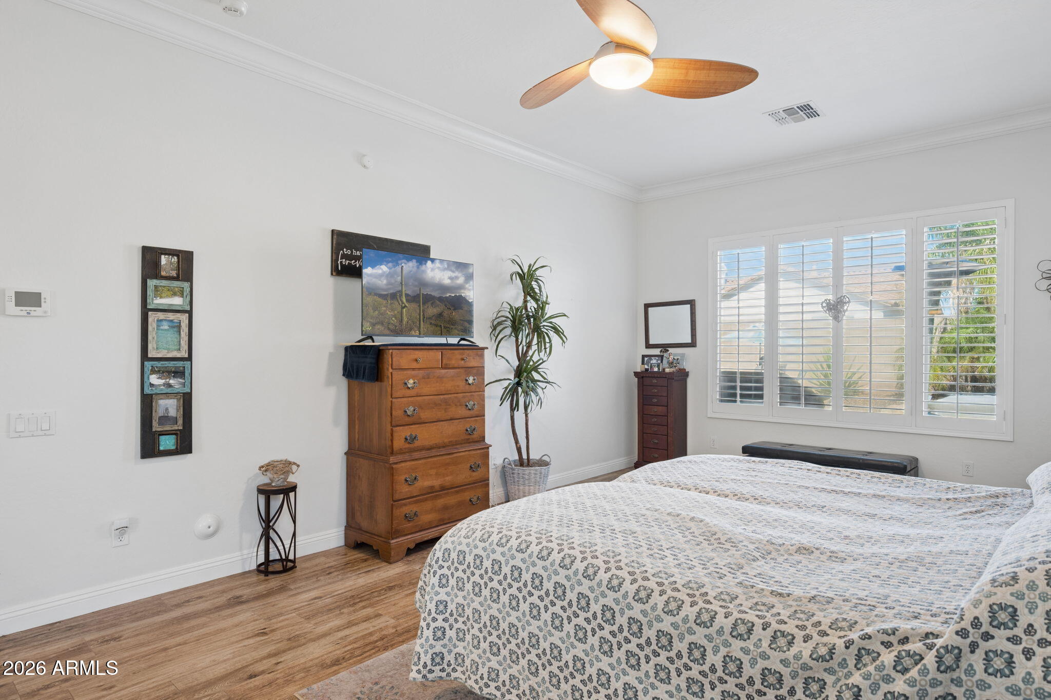 5508 West Parsons Road Phoenix, AZ 85083 - Photo 22 of 48 a bedroom with a bed and a chandelier