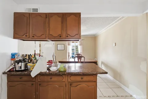 a kitchen with a stove and a wooden floor