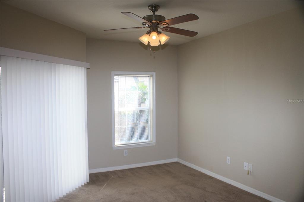 3621 Conroy Road, Unit 739 Orlando, FL 32839 - Photo 14 of 20 an empty room with windows and fan