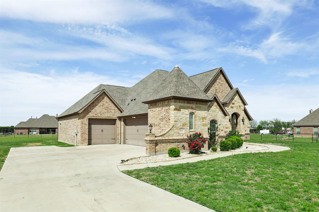 1020 Jesse James Lane Springtown, TX 76082 - Photo 1 of 38 a front view of a house with a yard
