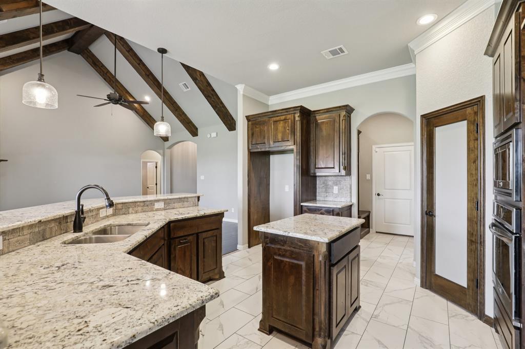 1020 Jesse James Lane Springtown, TX 76082 - Photo 12 of 38 a kitchen with a sink stove and refrigerator