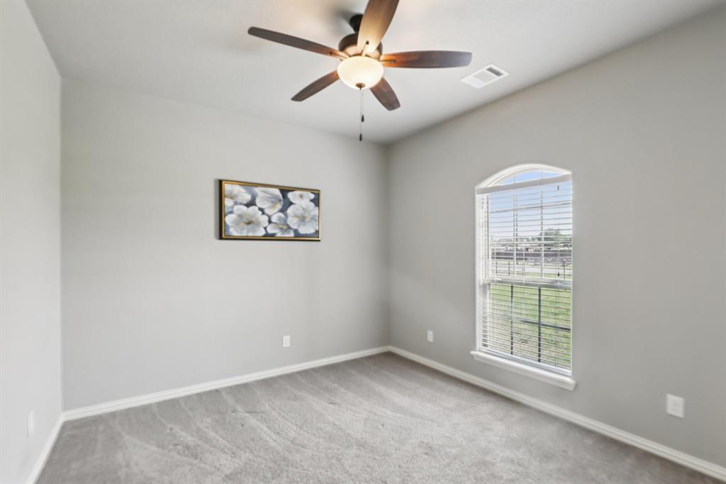 1020 Jesse James Lane Springtown, TX 76082 - Photo 15 of 38 an empty room with a window and a fan