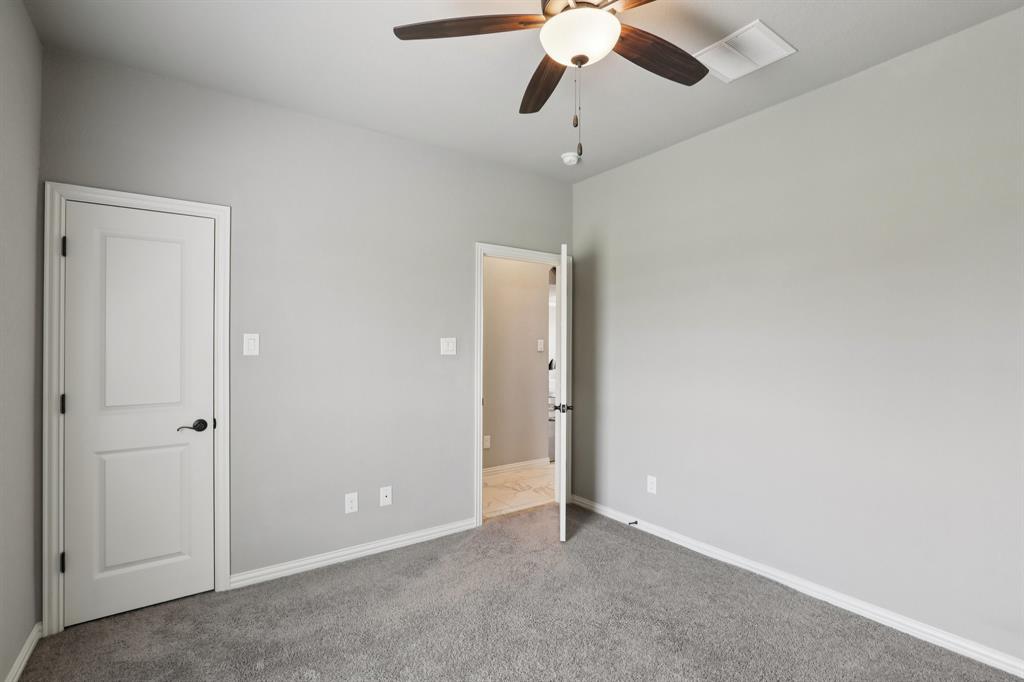 1020 Jesse James Lane Springtown, TX 76082 - Photo 16 of 38 an empty room with a chandelier fan and closet