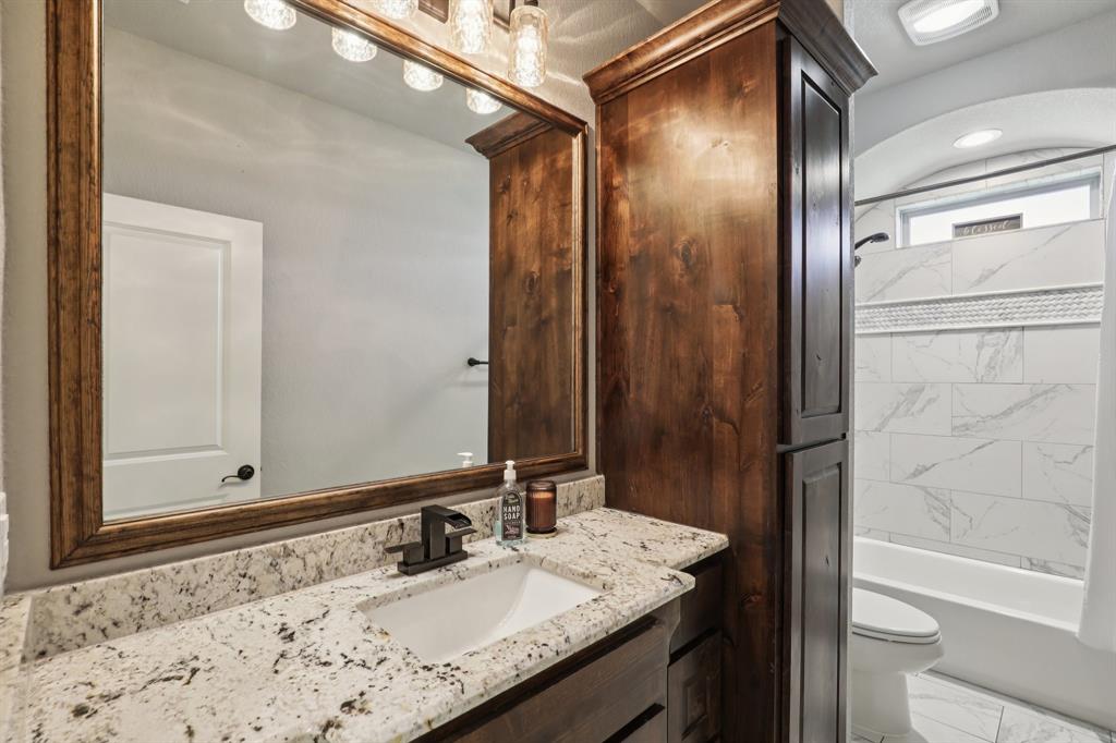1020 Jesse James Lane Springtown, TX 76082 - Photo 17 of 38 a bathroom with a granite countertop sink and a mirror