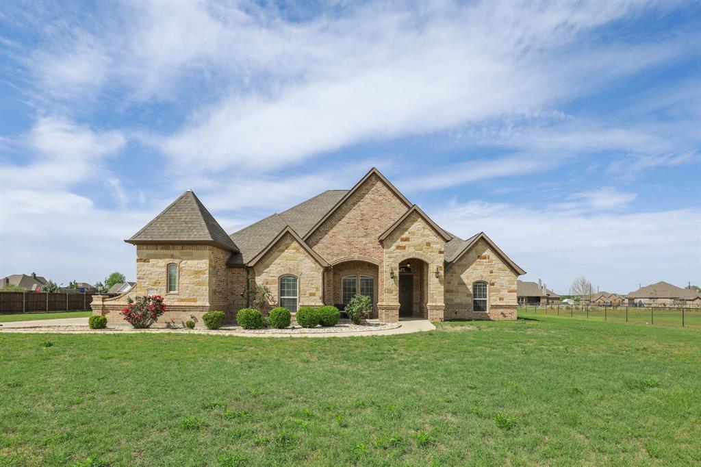 1020 Jesse James Lane Springtown, TX 76082 - Photo 3 of 38 a view of white house with a big yard and potted plants
