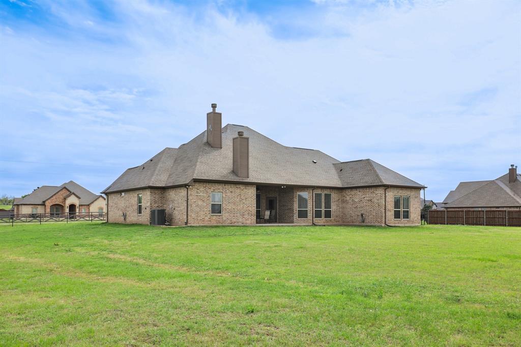 1020 Jesse James Lane Springtown, TX 76082 - Photo 36 of 38 a view of a house with a yard and sitting area