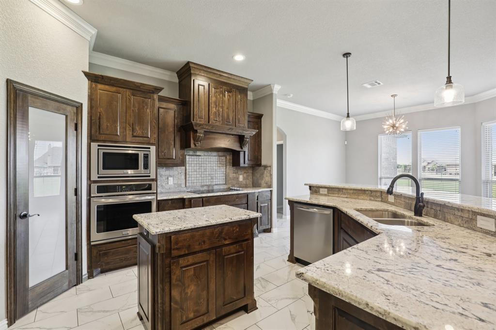 1020 Jesse James Lane Springtown, TX 76082 - Photo 10 of 38 a kitchen with a sink a stove and refrigerator