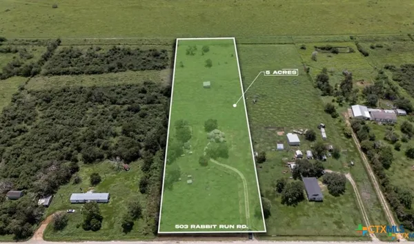 an aerial view of a residential houses with outdoor space
